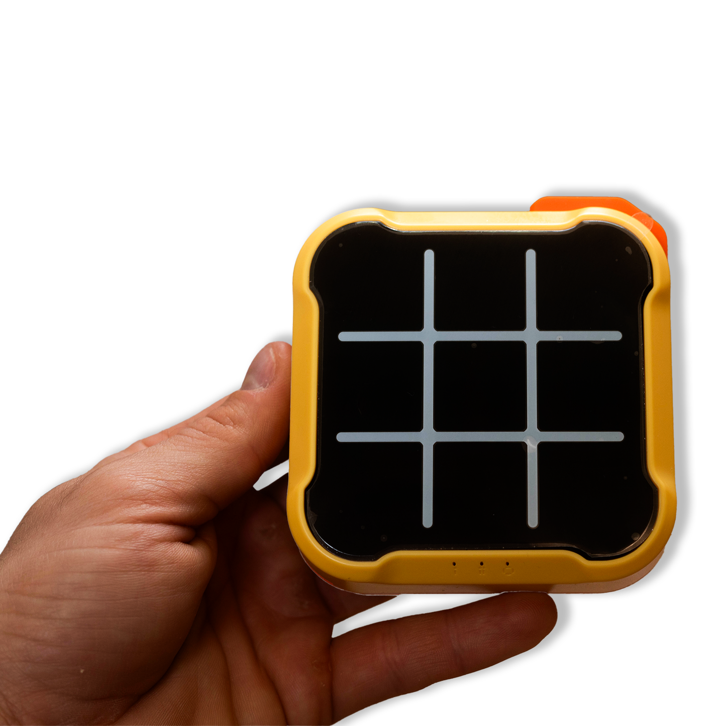 Person holding the yellow electronic Tic Tac Toe game board in hand