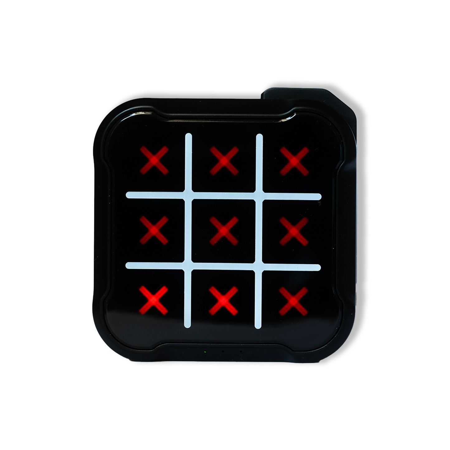Black electronic Tic Tac Toe game board powered on with lights glowing